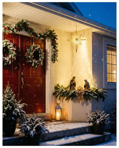 The display on a snowy front porch at night